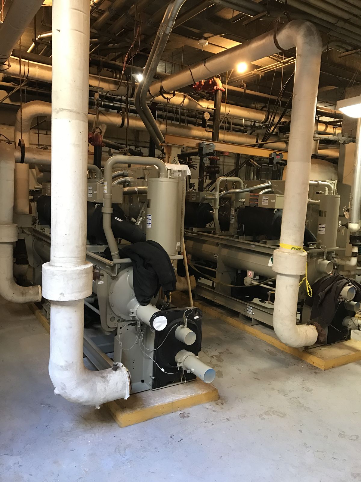 Boiler and pump equipment in a commercial mechanical room serviced by JP Air Conditioning & Heating