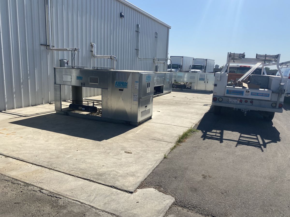 Multiple commercial HVAC package units staged in JP's yard before installation