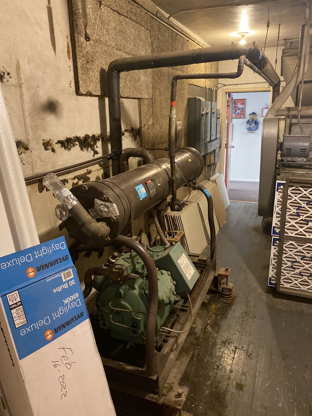 Commercial refrigeration compressor in a mechanical room
