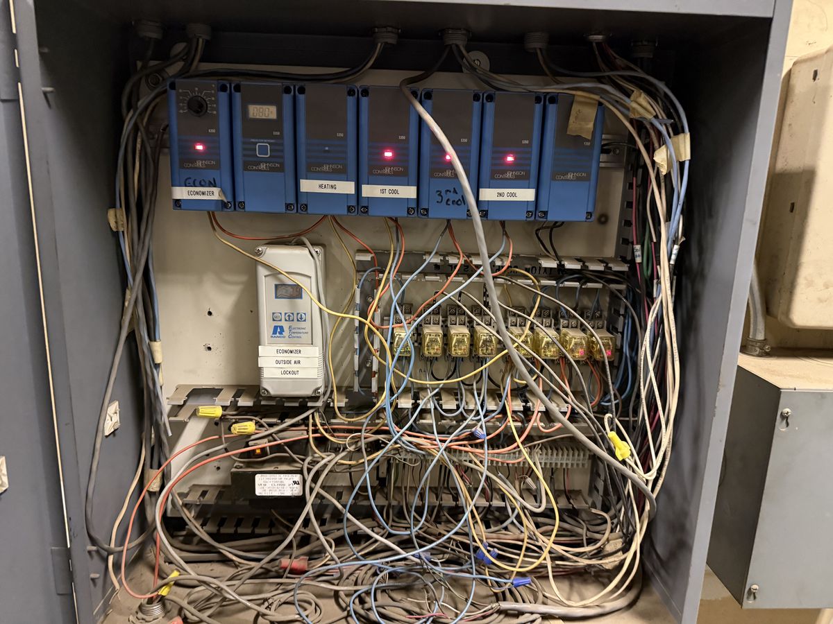 HVAC control panel wiring being checked during a preventive maintenance visit
